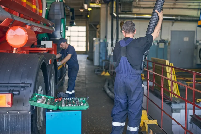 Two male worker giving a overall checking on the truck.